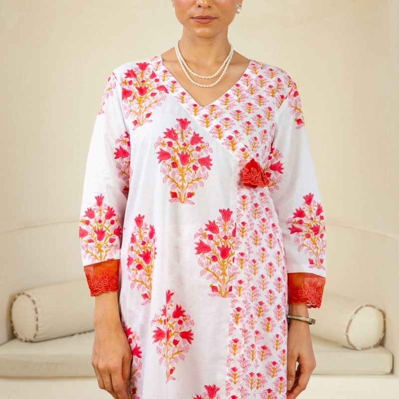 A woman standing in front of a white couch