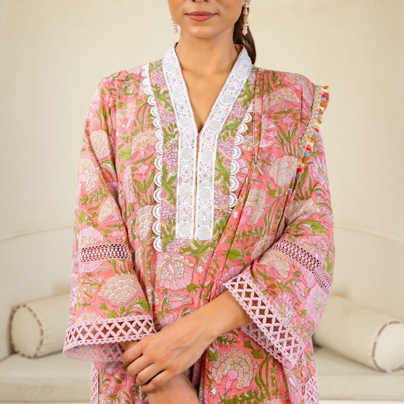 A woman standing in front of a white couch